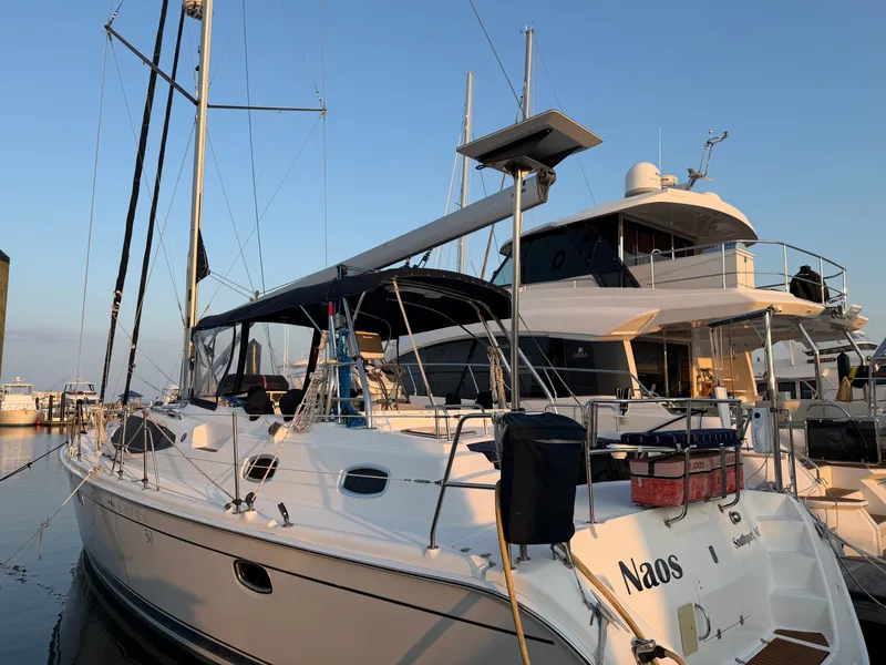 Slide: The Image of A 2009 Hunter 50 Center Cockpit yacht docked at a marina alongside other boats. - 13