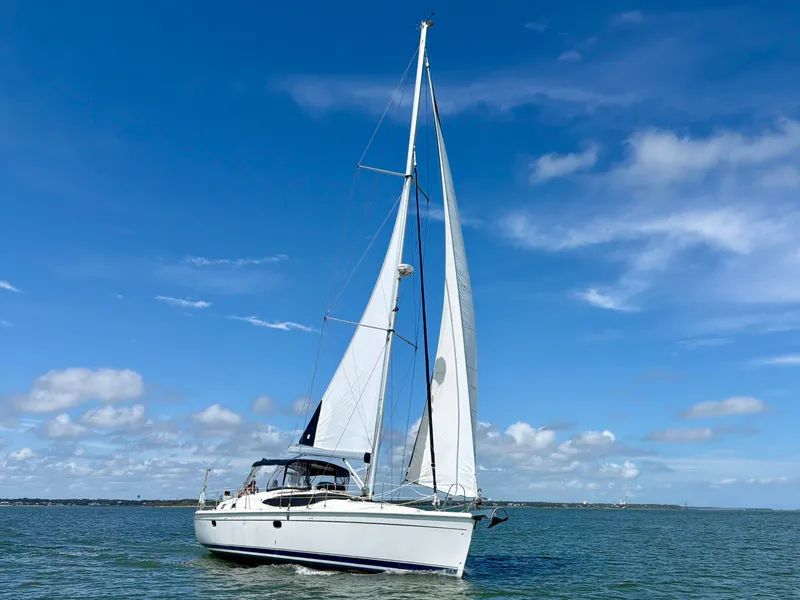 Slide: The Image of A white sailing yacht with two sails glides on calm waters under a blue sky. - 8