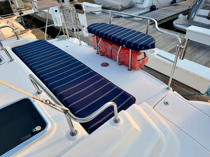 Slide: The Image of The image shows the deck of a 2009 Hunter 50 Center Cockpit with striped cushions. - 16