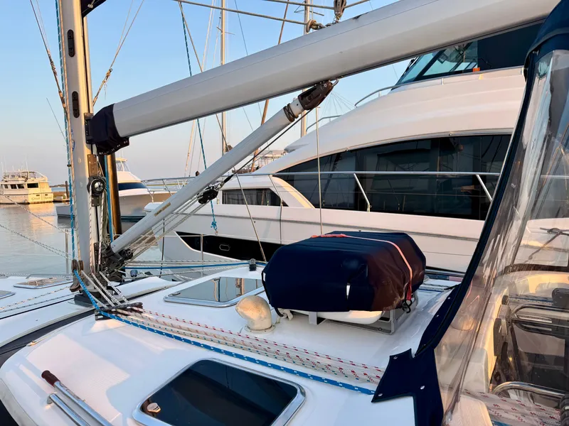 Slide: The Image of The image shows the deck of a 2009 Hunter 50 Center Cockpit at a marina. - 26