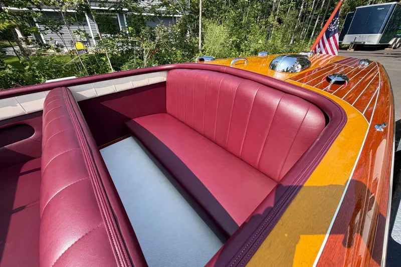 Slide: The Image of 1953 Chris Craft Riviera boat with burgundy leather seats and polished wood finish. - 13
