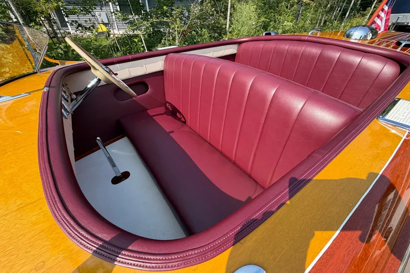 Slide: The Image of 1953 Chris Craft Riviera boat interior with red leather seats and wooden finish. - 12