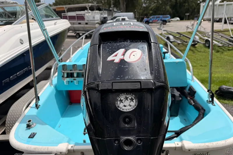 Slide: The Image of 2009 Boston Whaler 130 Sport boat with 40 HP engine, parked outdoors. - 21