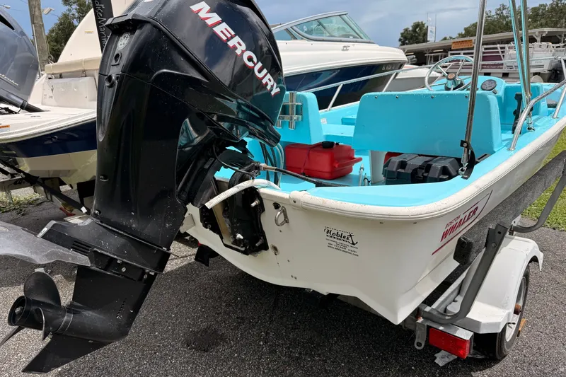 Slide: The Image of 2009 Boston Whaler 130 Sport boat with Mercury outboard motor on trailer. - 22