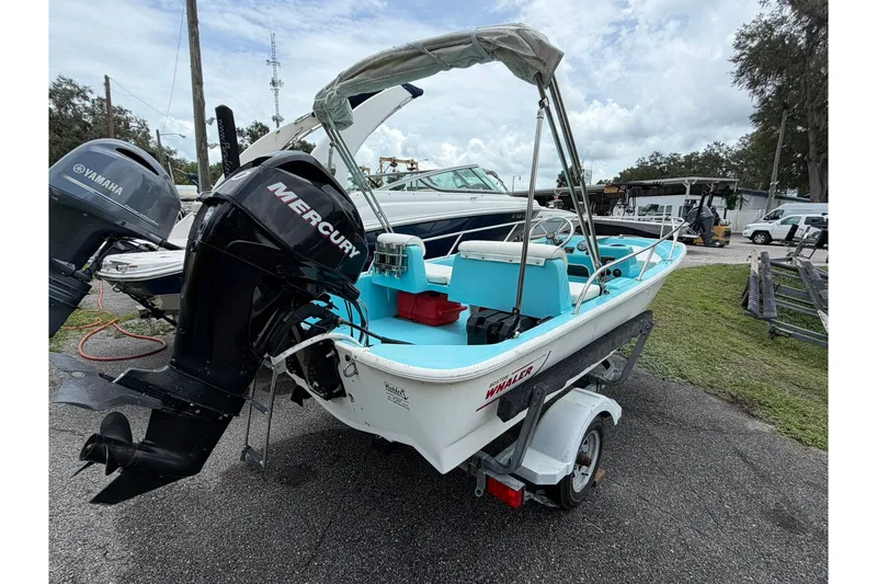Slide: The Image of 2009 Boston Whaler 130 Sport boat with Mercury engine on trailer. - 26