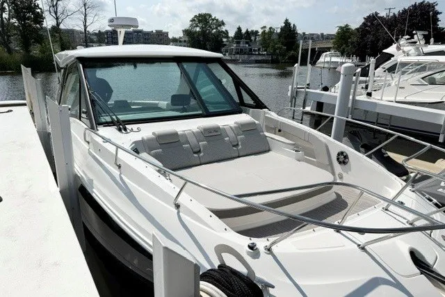 Slide: The Image of 2022 Sea Ray Sundancer 320 docked, showcasing sleek design and spacious deck. - 1