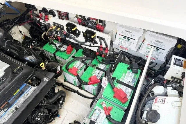 Slide: The Image of Engine compartment of 2022 Sea Ray Sundancer 320 with batteries and wiring. - 17