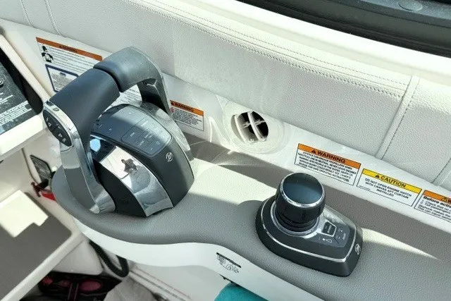 Slide: The Image of Control panel of 2022 Sea Ray Sundancer 320 boat with throttle and joystick. - 13