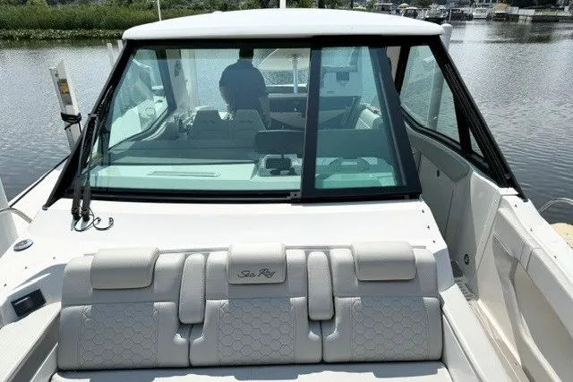 Slide: The Image of 2022 Sea Ray Sundancer 320 boat interior with seating and windshield view. - 21
