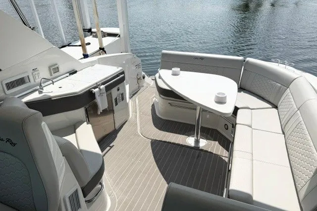 Slide: The Image of 2022 Sea Ray Sundancer 320 yacht interior with elegant seating and dining area. - 11