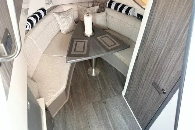 Slide: The Image of 2022 Sea Ray Sundancer 320 cabin interior with modern seating and table. - 30