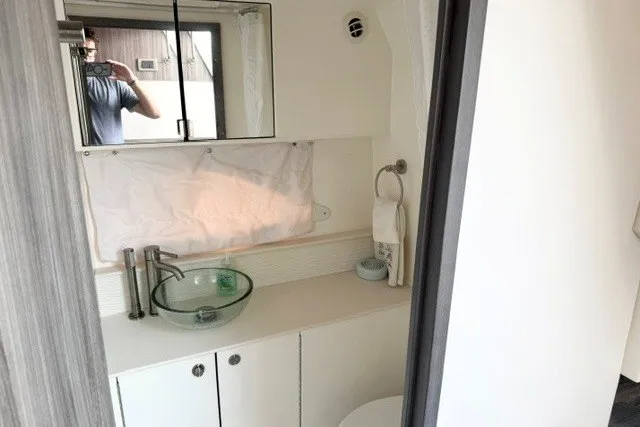 Slide: The Image of Modern bathroom interior of 2022 Sea Ray Sundancer 320 yacht with glass sink and mirror. - 26