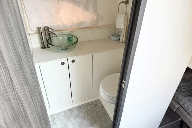 Slide: The Image of Modern bathroom in 2022 Sea Ray Sundancer 320 yacht with glass sink and compact design. - 29