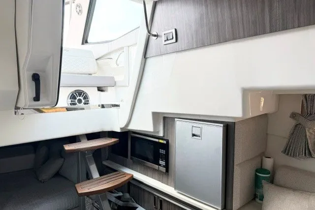 Slide: The Image of Interior of 2022 Sea Ray Sundancer 320 yacht with modern amenities and wooden steps. - 25