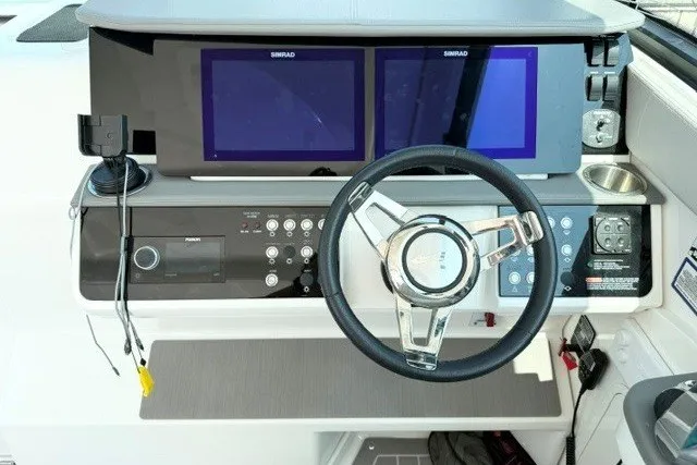 Slide: The Image of 2022 Sea Ray Sundancer 320 helm with dual Simrad displays and modern steering wheel. - 14