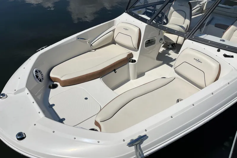 Slide: The Image of 2023 Stingray 191 DC boat interior with white and tan seating, sleek design. - 20