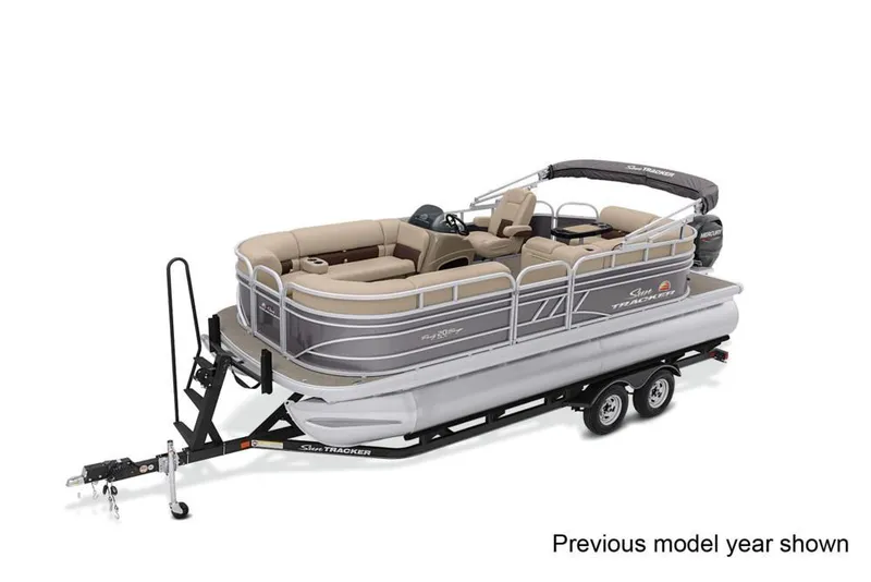 The Image of 2022 Sun Tracker Party Barge 20 DLX on a trailer, featuring beige seating and a black Bimini top. - 1