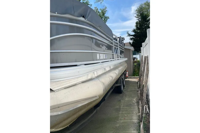 Slide: The Image of 2022 Sun Tracker Party Barge 20 DLX pontoon boat parked outdoors. - 16