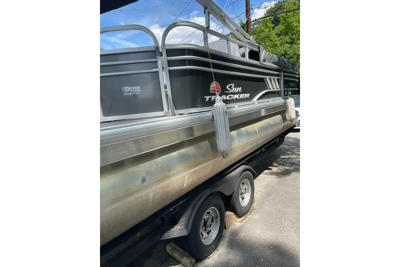 Slide: The Image of 2022 Sun Tracker Party Barge 20 DLX pontoon boat on trailer, side view. - 14