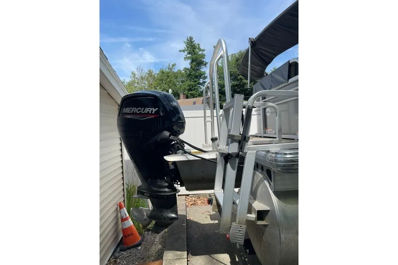 Slide: The Image of 2022 Sun Tracker Party Barge 20 DLX with Mercury outboard motor, docked outdoors. - 15