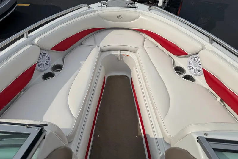 Slide: The Image of 2011 Crownline 21 SS boat interior with white and red seating, cup holders, and speakers. - 5