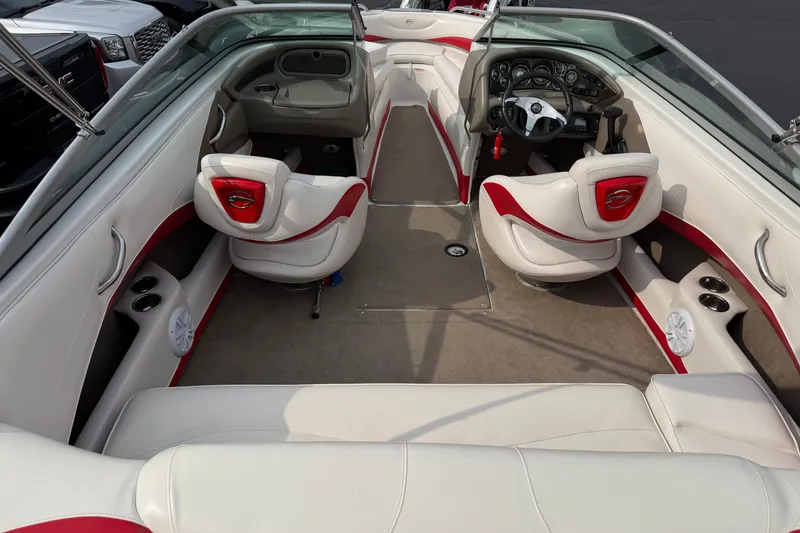 Slide: The Image of 2011 Crownline 21 SS boat interior with white and red seating, steering wheel, and dashboard. - 1
