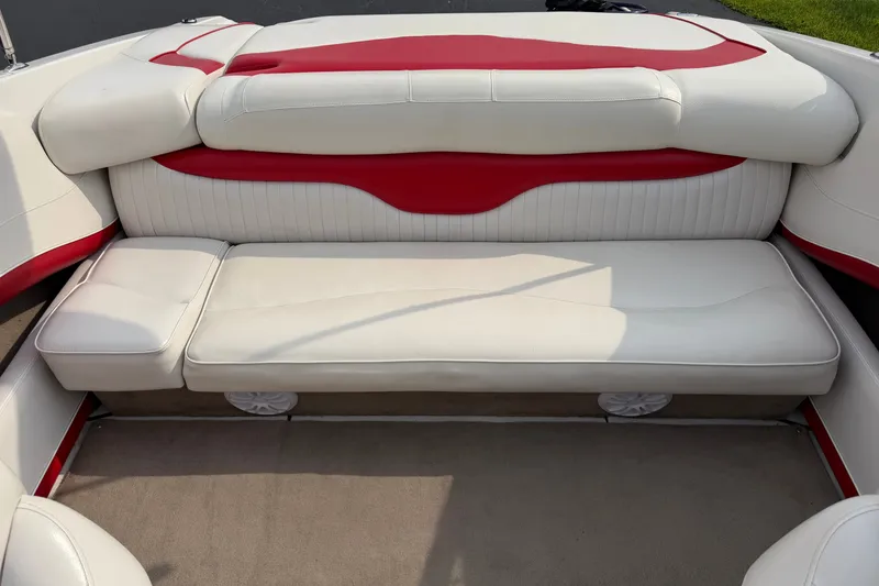 Slide: The Image of 2011 Crownline 21 SS boat interior with white and red cushioned seating. - 14