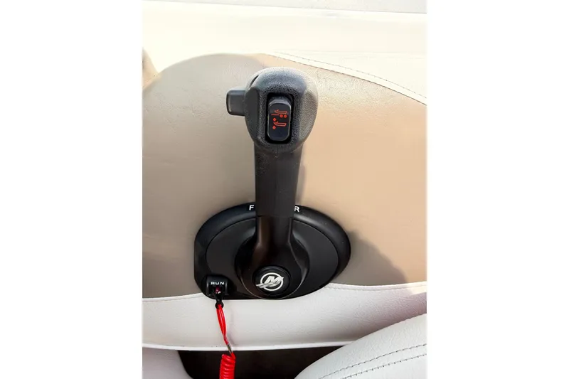 Slide: The Image of Throttle control lever of a 2011 Crownline 21 SS boat, featuring forward and reverse settings. - 12
