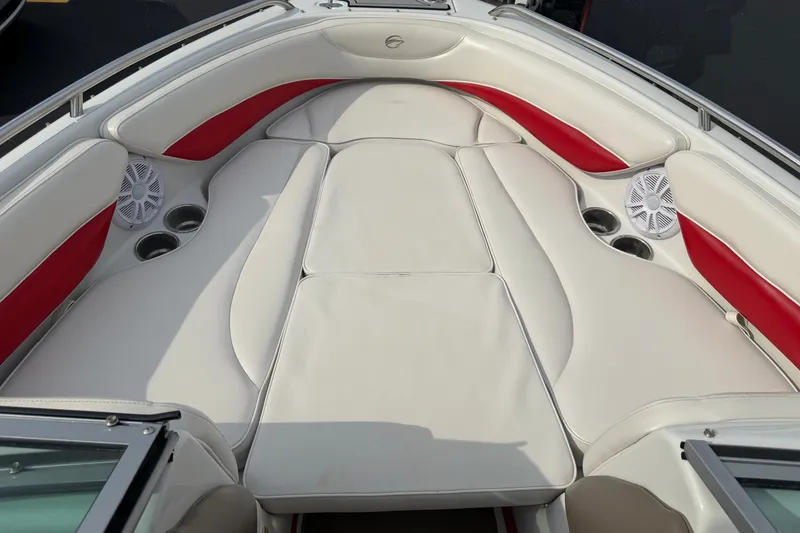 Slide: The Image of 2011 Crownline 21 SS boat interior with white and red cushioned seating and cup holders. - 4
