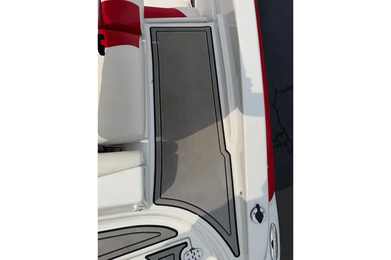Slide: The Image of 2011 Crownline 21 SS boat interior with red and white seating and sleek flooring design. - 2