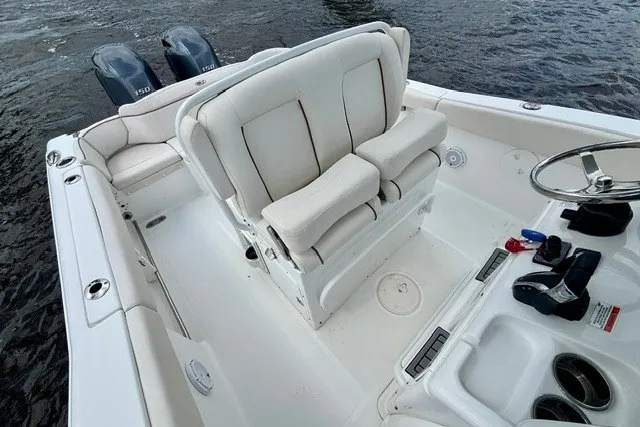 Slide: The Image of 2022 Sea Hunt Ultra 265SE boat interior with dual engines and comfortable seating. - 9