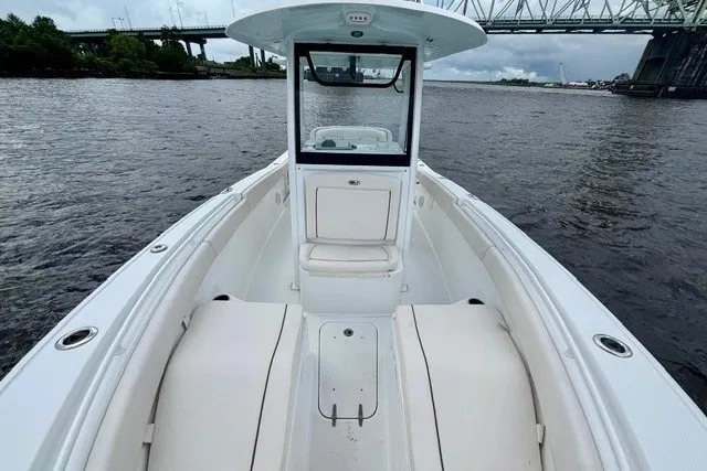 Slide: The Image of 2022 Sea Hunt Ultra 265SE boat on water, showcasing spacious deck and seating. - 11
