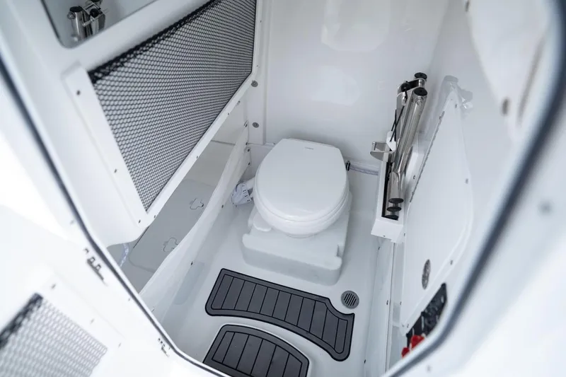 Slide: The Image of Manufacturer Provided Image: The image shows a clean, modern boat toilet with gray floor mats and storage space. - 8