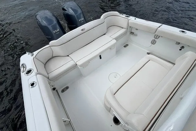 Slide: The Image of 2022 Sea Hunt Ultra 265SE boat interior with twin engines and spacious seating. - 7