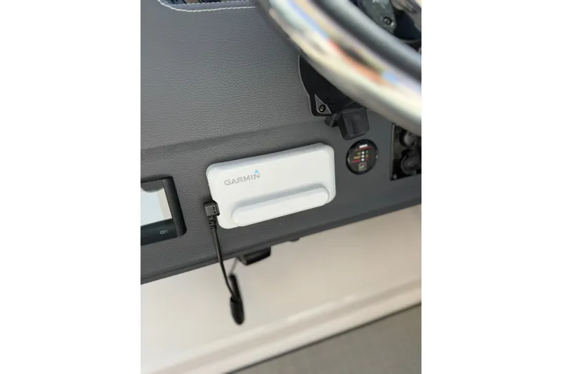 Slide: The Image of Garmin device on 2022 Regal 33 OBX boat dashboard, featuring sleek design and modern controls. - 22