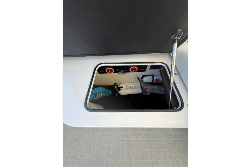 Slide: The Image of Storage compartment of 2022 Regal 33 OBX boat with safety equipment. - 39