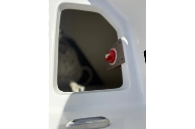 Slide: The Image of Compartment with red switch inside a 2022 Regal 33 OBX boat. - 46