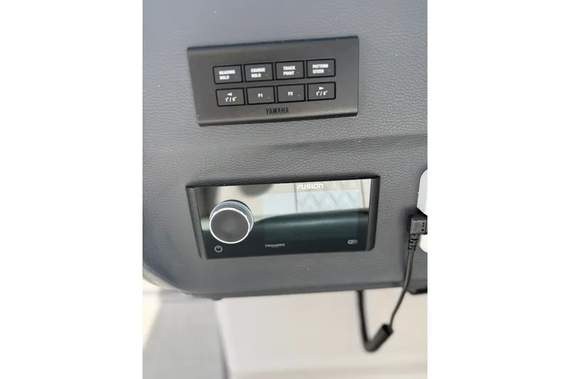 Slide: The Image of Control panel and Fusion stereo on 2022 Regal 33 OBX boat dashboard. - 24
