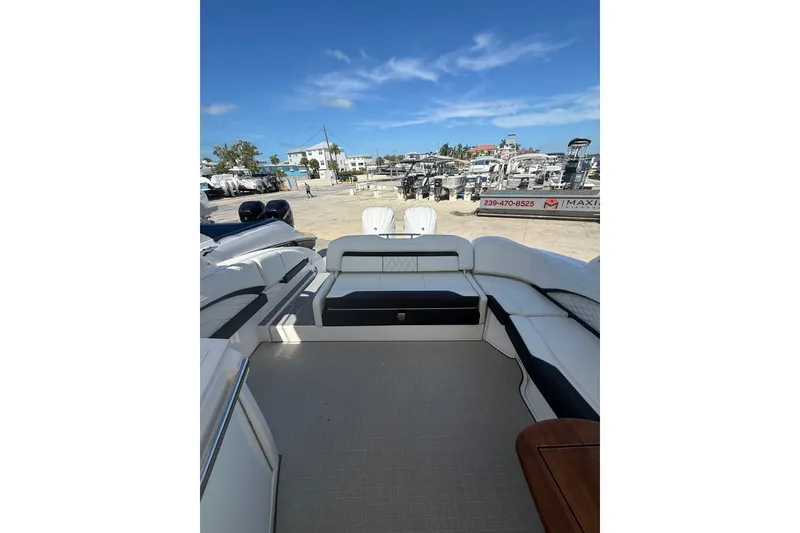 Slide: The Image of 2022 Regal 33 OBX boat interior with spacious seating and clear blue sky. - 8