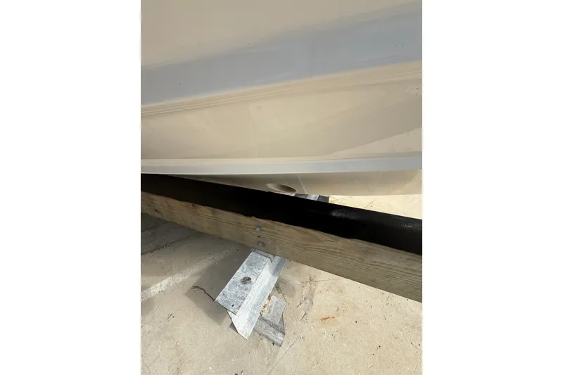 Slide: The Image of 2022 Regal 33 OBX boat hull on trailer, close-up view. - 41