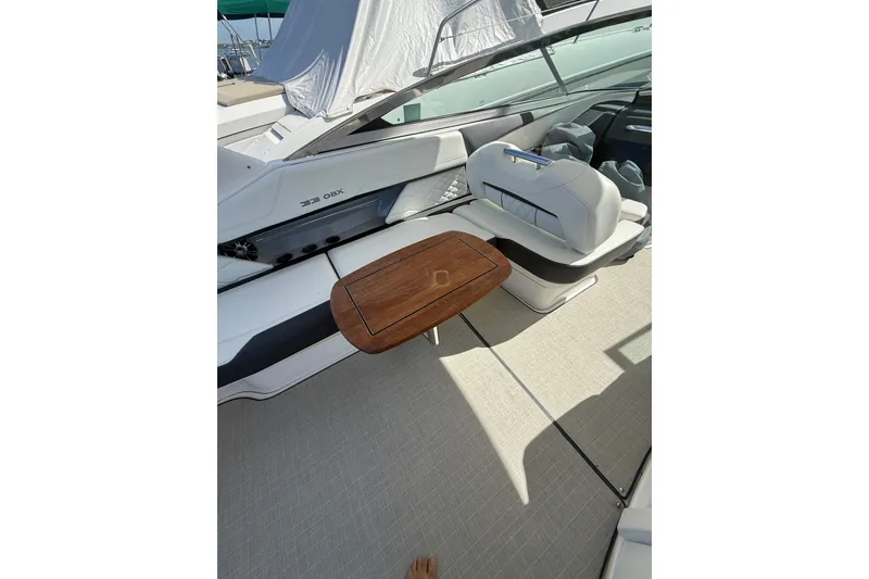 Slide: The Image of 2022 Regal 33 OBX boat interior with seating and wooden table. - 6