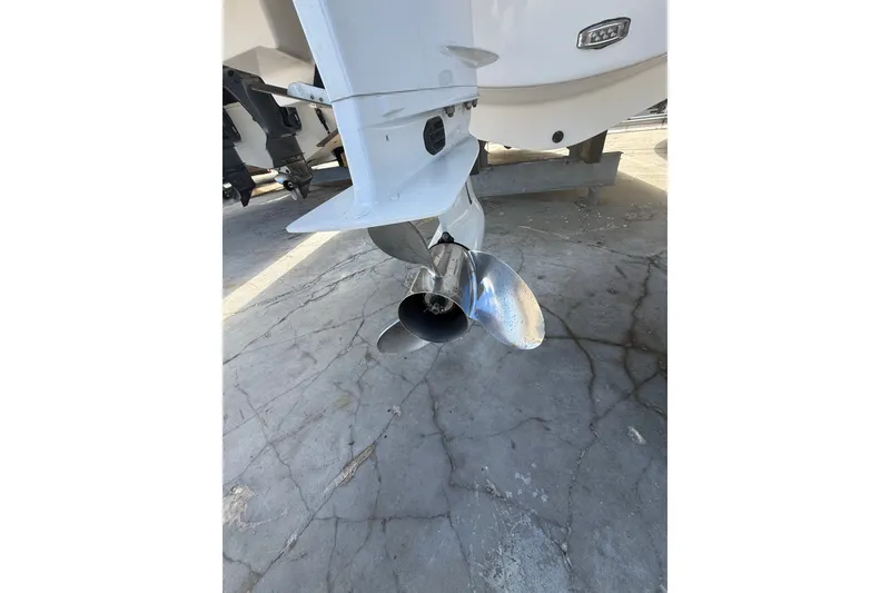 Slide: The Image of 2022 Regal 33 OBX boat propeller on concrete surface, showcasing sleek design. - 42
