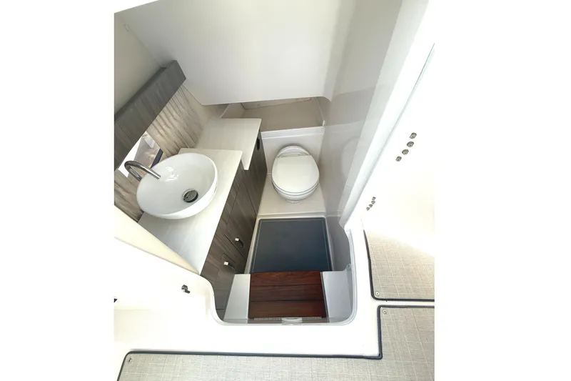 Slide: The Image of 2022 Regal 33 OBX boat interior bathroom with sink and toilet. - 25