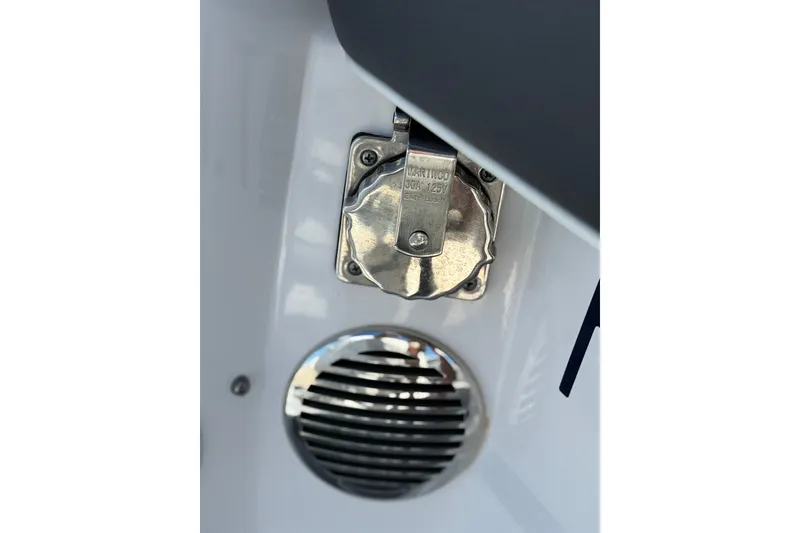 Slide: The Image of Close-up of a 2022 Regal 33 OBX boat's electrical outlet and vent. - 44