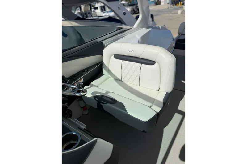 Slide: The Image of Luxurious seating on a 2022 Regal 33 OBX boat, featuring elegant white upholstery. - 18