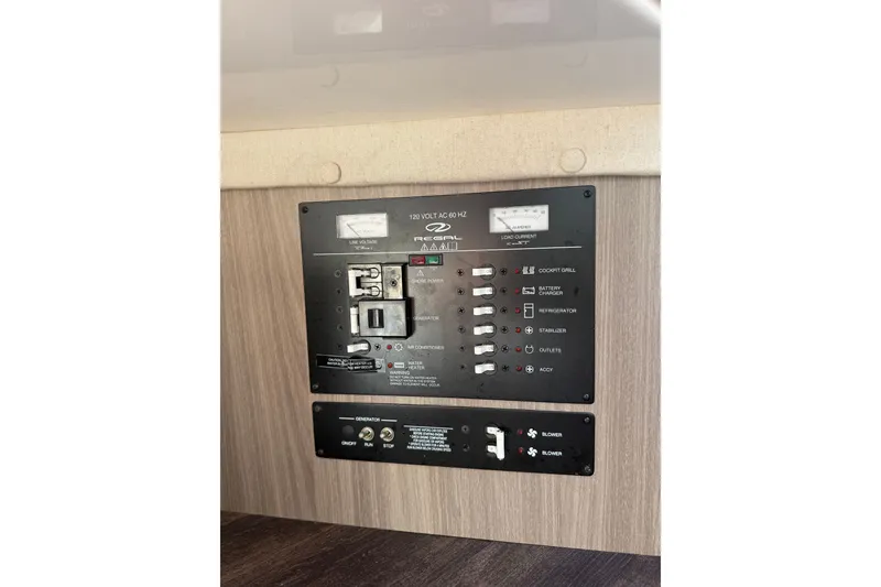 Slide: The Image of Electrical control panel of 2022 Regal 33 OBX boat, featuring switches and indicators. - 45