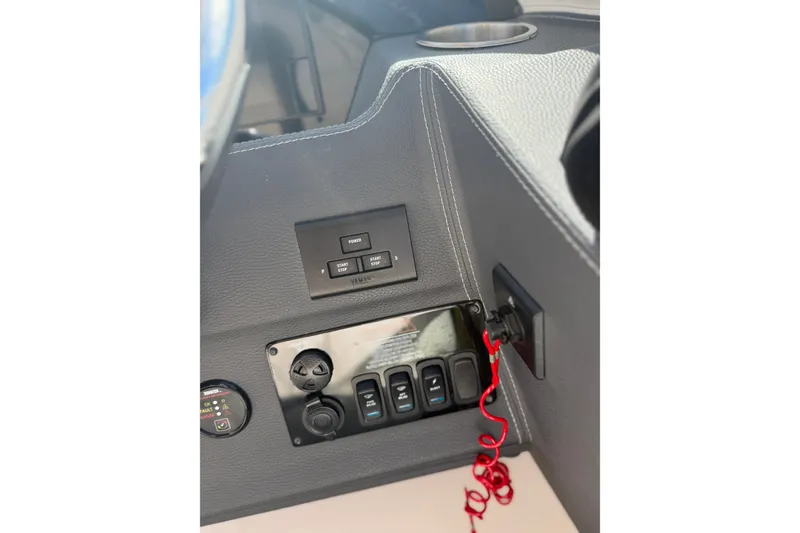Slide: The Image of Control panel of 2022 Regal 33 OBX boat with switches and red safety cord. - 21