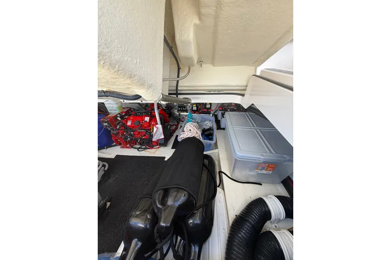 Slide: The Image of Interior view of 2022 Regal 33 OBX boat storage compartment with equipment and containers. - 38