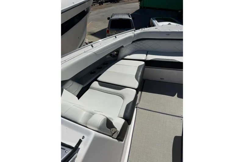 Slide: The Image of 2022 Regal 33 OBX boat interior with luxurious white seating and cup holders. - 34
