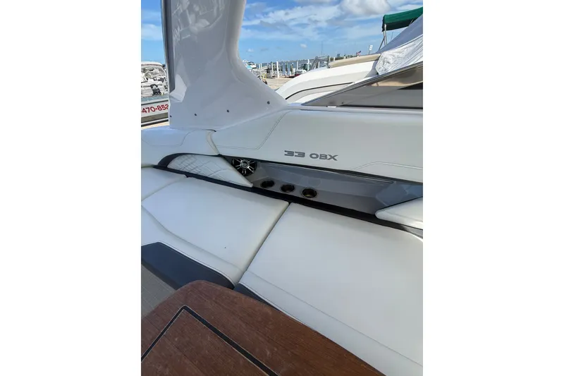 Slide: The Image of 2022 Regal 33 OBX boat interior with white seating and sleek design. - 11